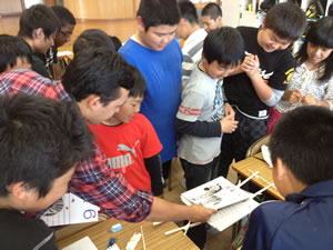 Kids making chopstick bridge